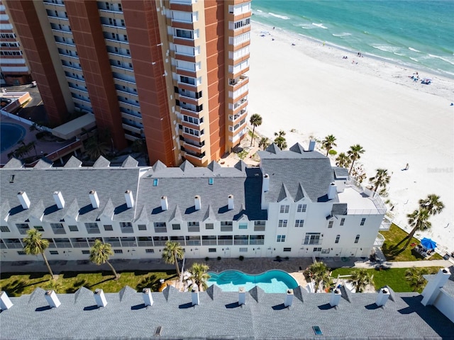 bird's eye view featuring a water view and a view of the beach