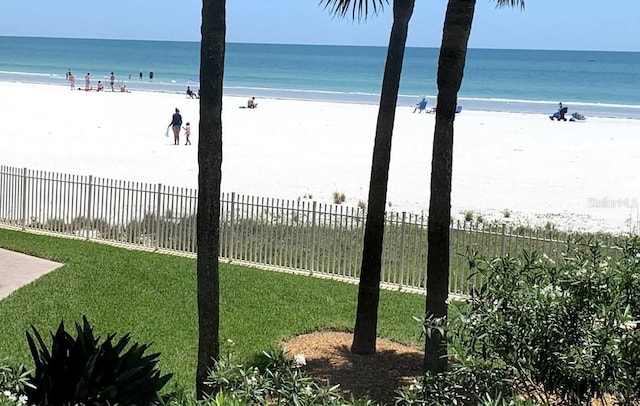 water view featuring a view of the beach and fence