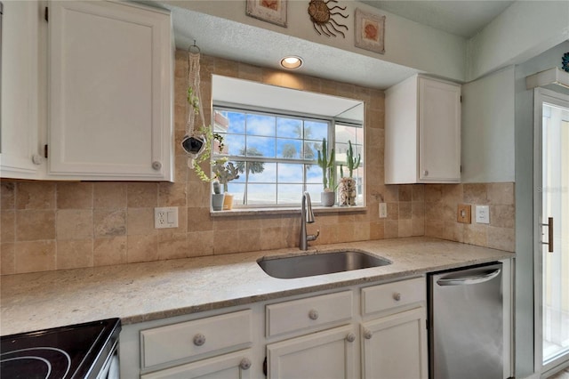 kitchen with a sink, white cabinets, and range with electric stovetop