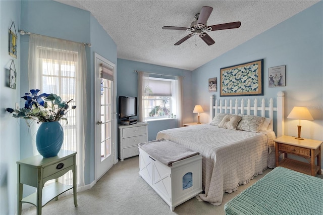bedroom with light colored carpet, a ceiling fan, a textured ceiling, and vaulted ceiling