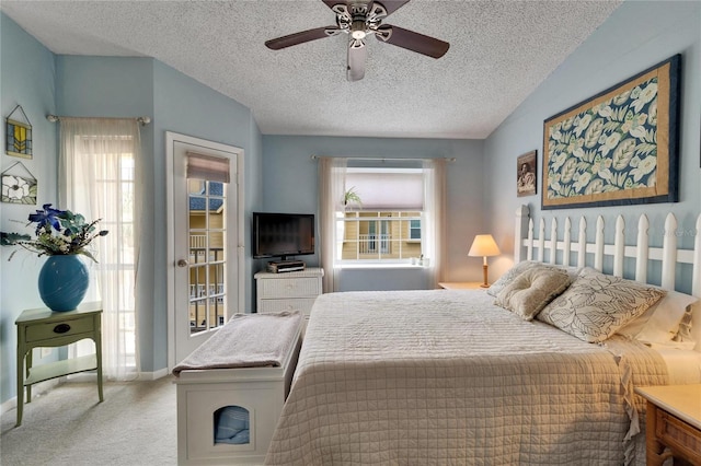carpeted bedroom featuring access to outside, a ceiling fan, and a textured ceiling