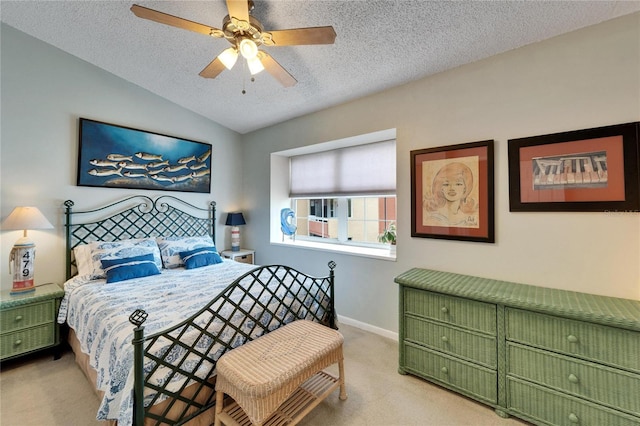 bedroom featuring ceiling fan, light colored carpet, a textured ceiling, baseboards, and vaulted ceiling