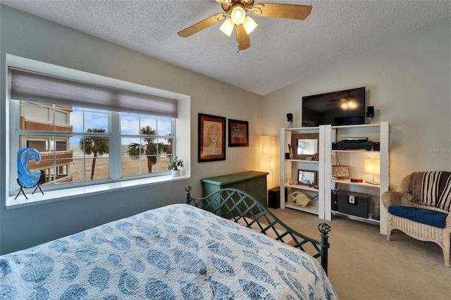 bedroom featuring carpet flooring, a textured ceiling, ceiling fan, and vaulted ceiling