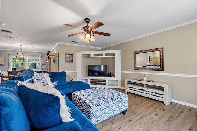 living area with ceiling fan, a textured ceiling, visible vents, light wood-style floors, and crown molding