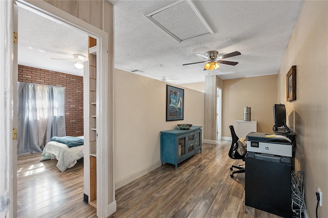 office area with ceiling fan, a textured ceiling, and wood finished floors