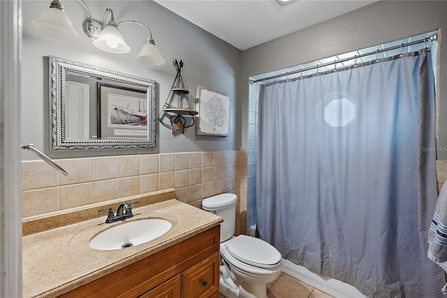 bathroom featuring toilet, tile patterned flooring, vanity, and tile walls