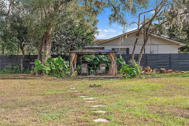 view of yard with a fenced backyard and a gazebo