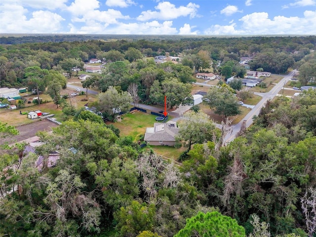 drone / aerial view with a wooded view