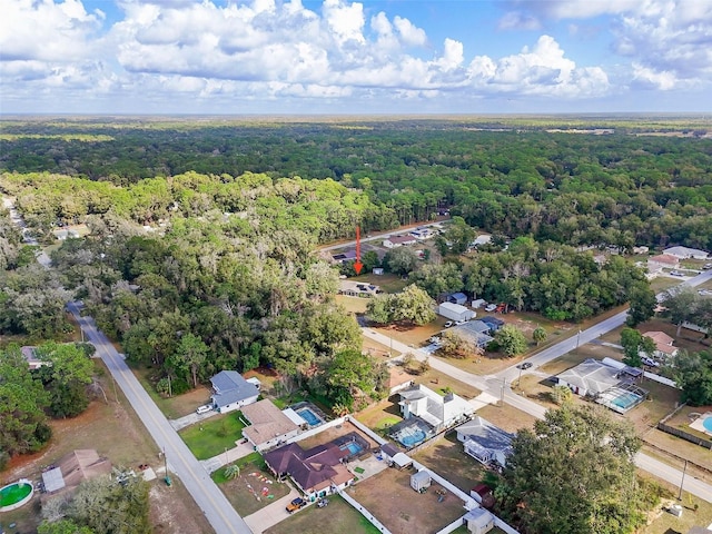 aerial view with a wooded view and a residential view