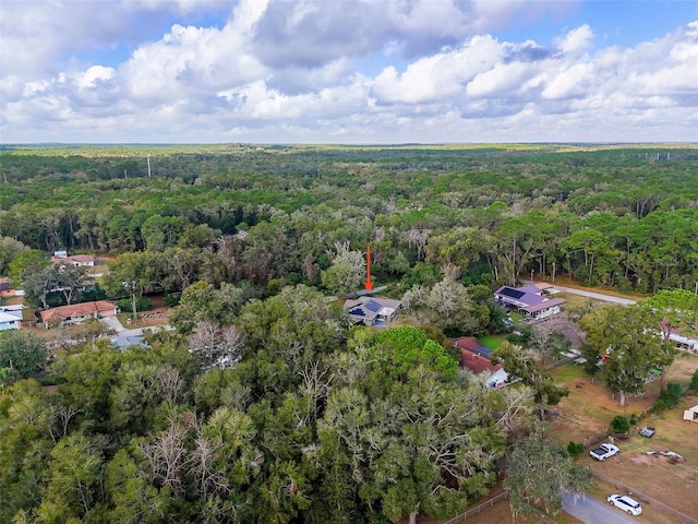 drone / aerial view featuring a wooded view