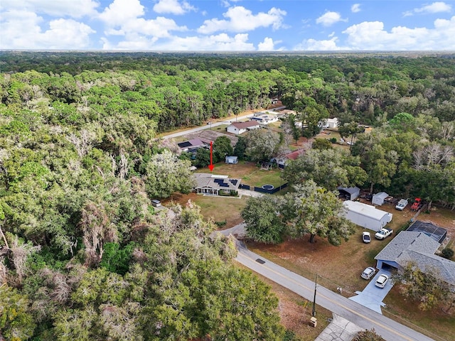 birds eye view of property featuring a view of trees