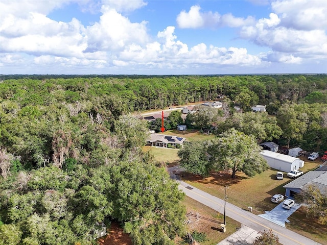 drone / aerial view featuring a wooded view