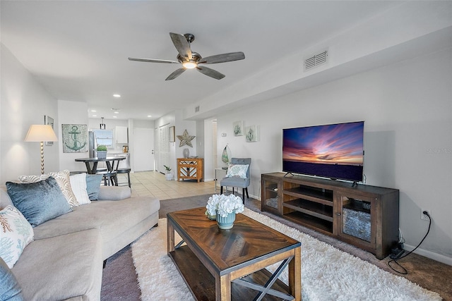 tiled living room featuring ceiling fan