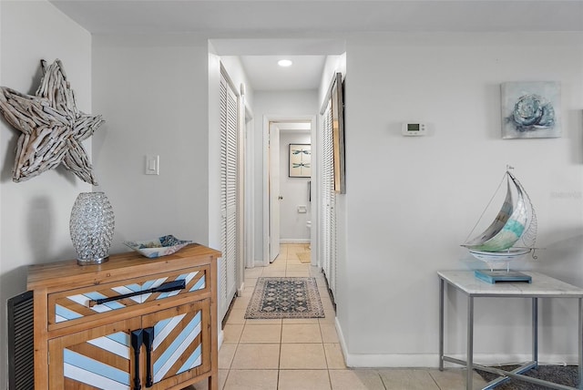 hall featuring light tile patterned floors