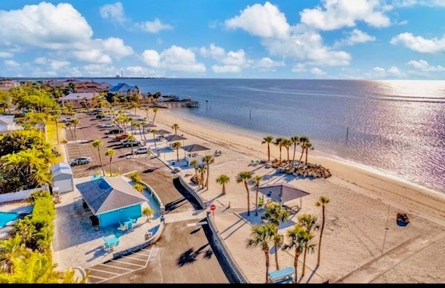 aerial view with a water view and a beach view