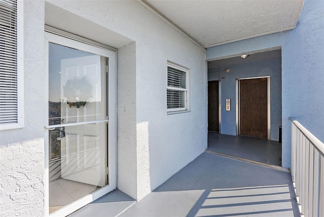 entrance to property featuring stucco siding