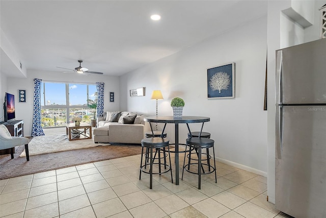 dining space featuring light tile patterned floors, baseboards, a ceiling fan, and recessed lighting