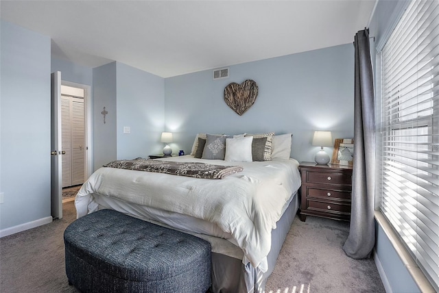 bedroom with baseboards, visible vents, and carpet flooring