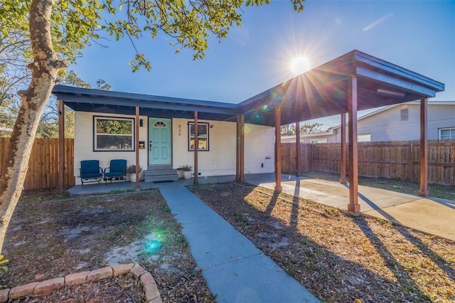 view of front of property with covered porch and a carport