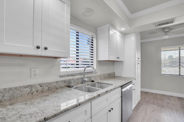 kitchen with white cabinets, light stone counters, ornamental molding, sink, and dishwasher