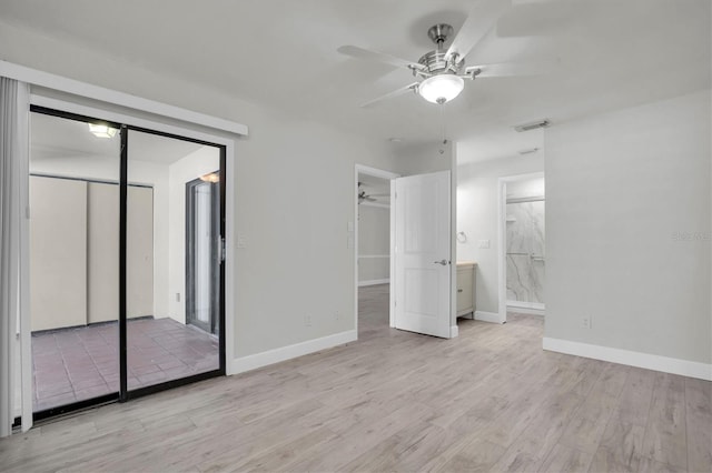 unfurnished bedroom with light wood-type flooring, ensuite bathroom, and ceiling fan