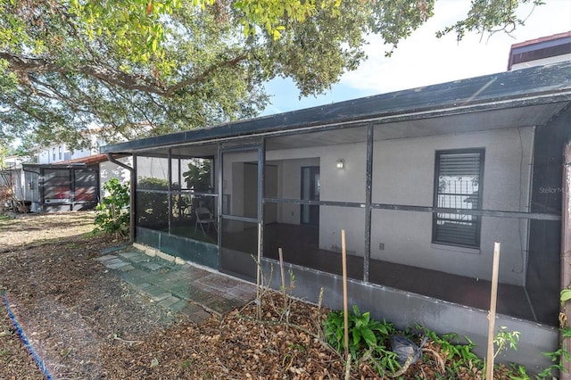 view of property exterior with a sunroom