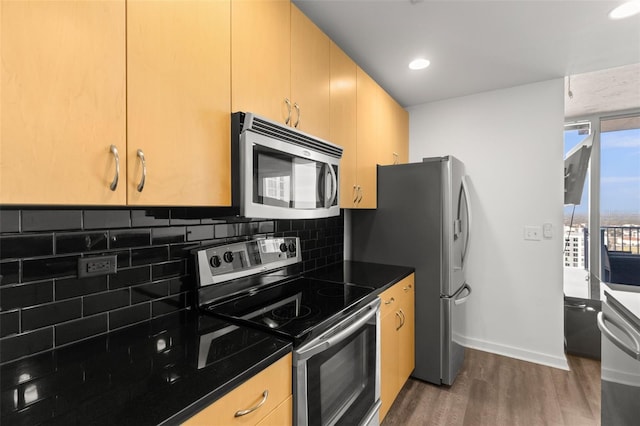 kitchen featuring light brown cabinets, tasteful backsplash, stainless steel appliances, and dark wood-type flooring