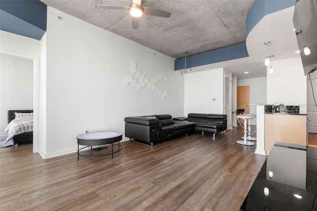 living room featuring hardwood / wood-style floors and ceiling fan