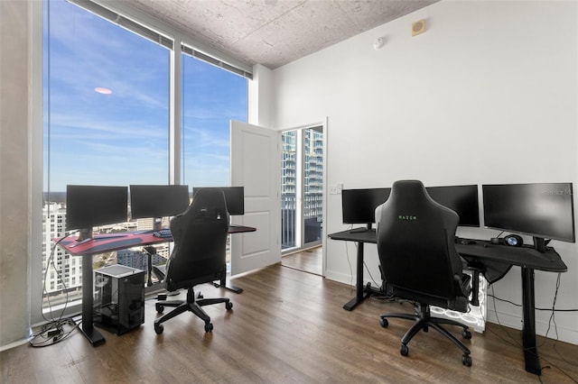 office with hardwood / wood-style flooring and expansive windows