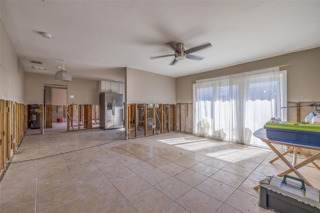 tiled empty room with ceiling fan