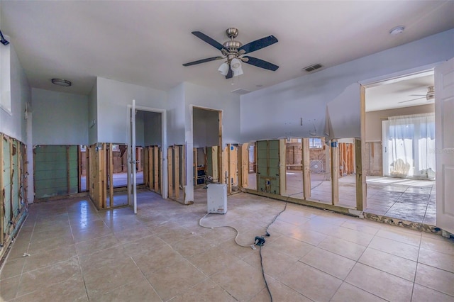 tiled empty room with ceiling fan