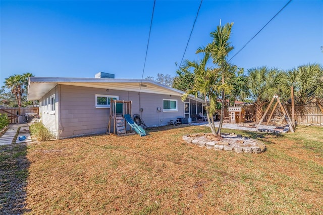 rear view of property with a yard