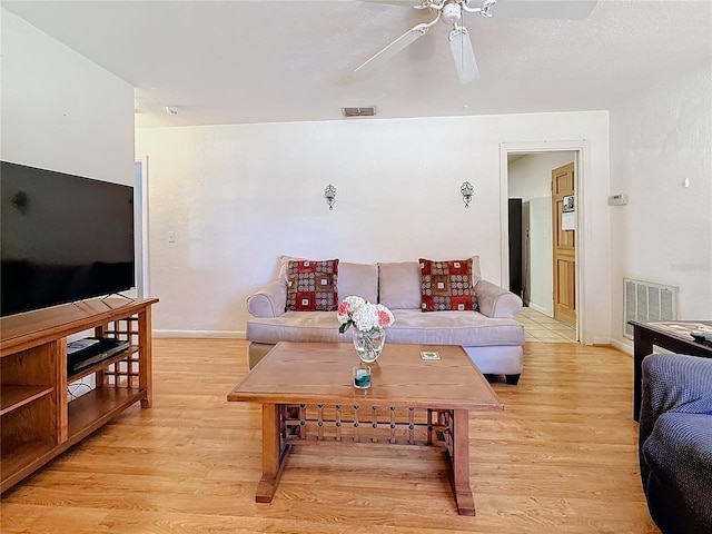 living room with ceiling fan and light wood-type flooring