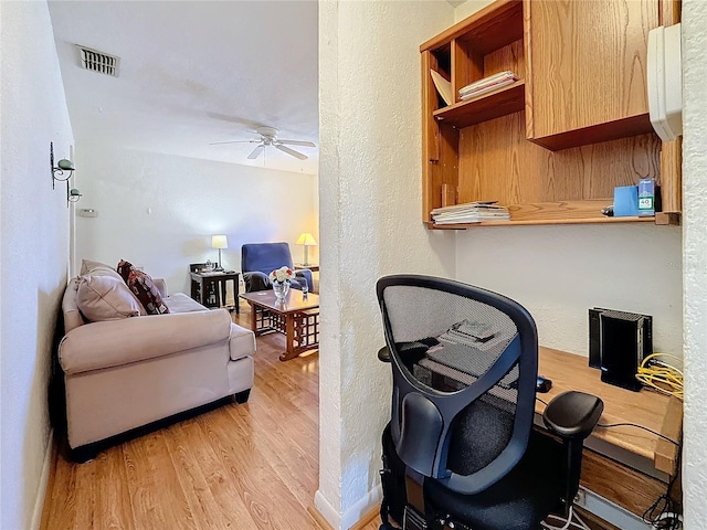 office space featuring ceiling fan and light hardwood / wood-style flooring