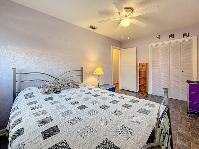 tiled bedroom featuring a closet and ceiling fan