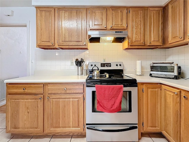 kitchen featuring stainless steel electric range oven and decorative backsplash