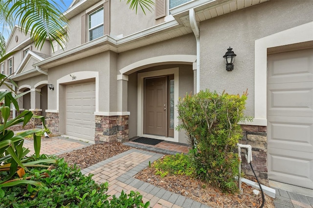 view of exterior entry with a garage