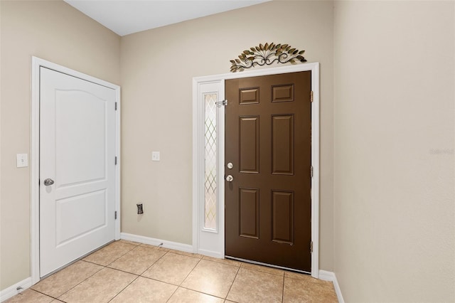 foyer entrance with light tile patterned floors