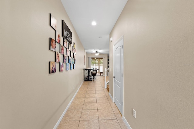 hall featuring light tile patterned floors