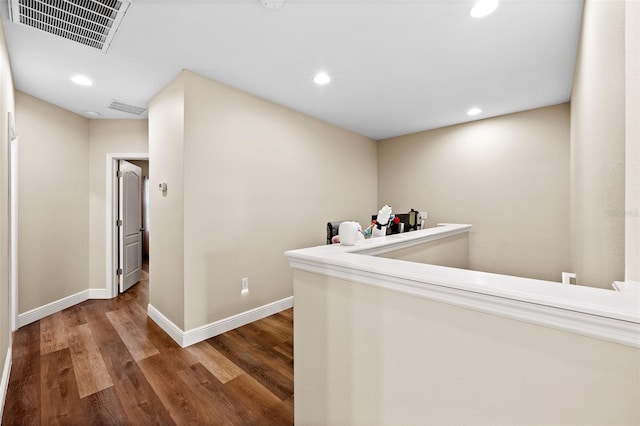 corridor with hardwood / wood-style floors