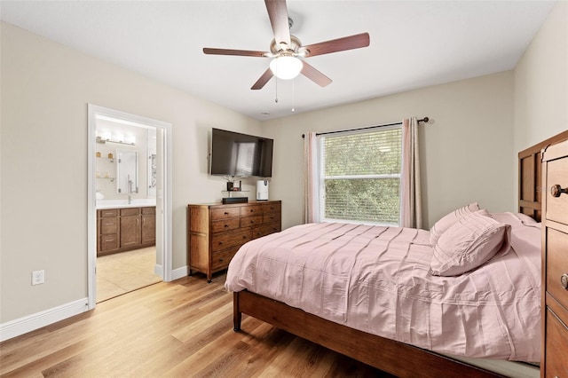 bedroom featuring ensuite bath, ceiling fan, and light wood-type flooring