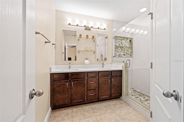 bathroom featuring tile patterned floors, vanity, and an enclosed shower