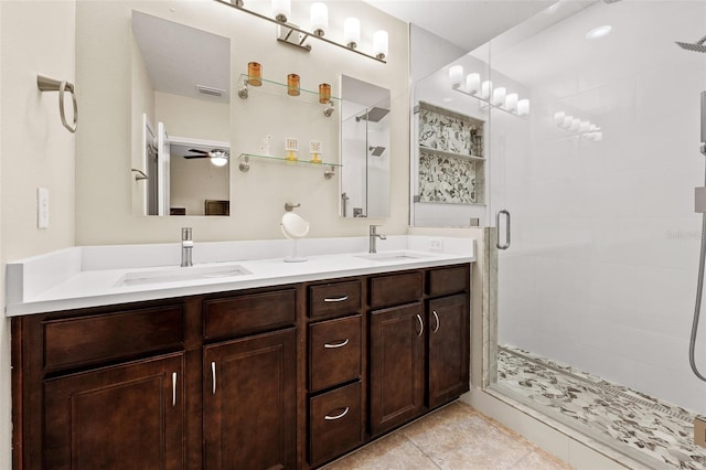 bathroom with vanity, tile patterned floors, ceiling fan, and a shower with shower door