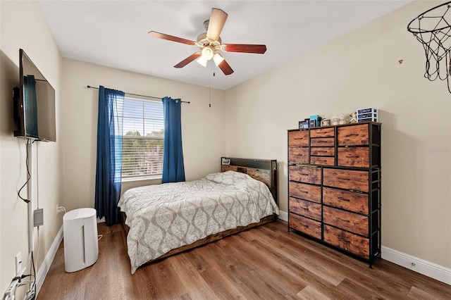 bedroom featuring hardwood / wood-style floors and ceiling fan