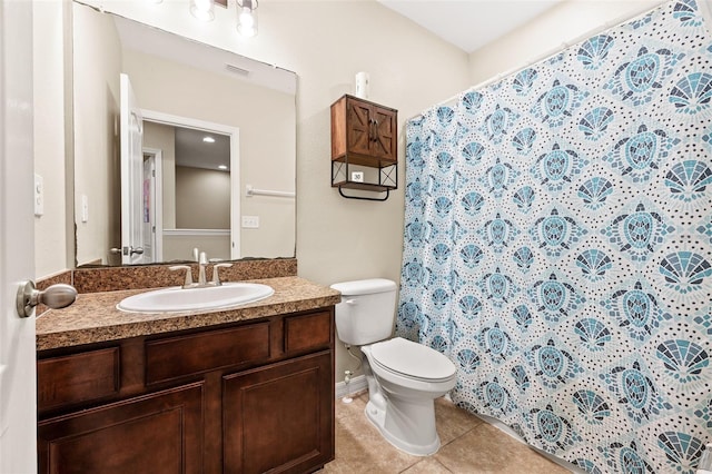 bathroom with tile patterned flooring, vanity, and toilet