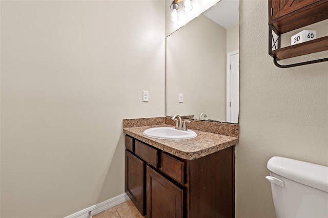 bathroom with tile patterned floors, vanity, and toilet