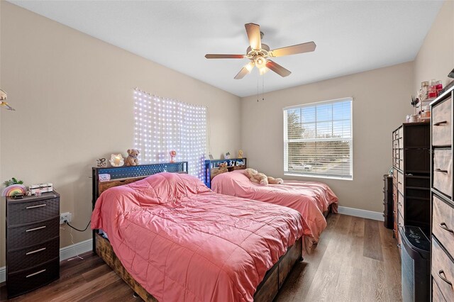 bedroom with ceiling fan and dark wood-type flooring