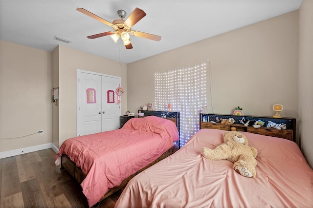 bedroom featuring ceiling fan, a closet, and dark hardwood / wood-style floors