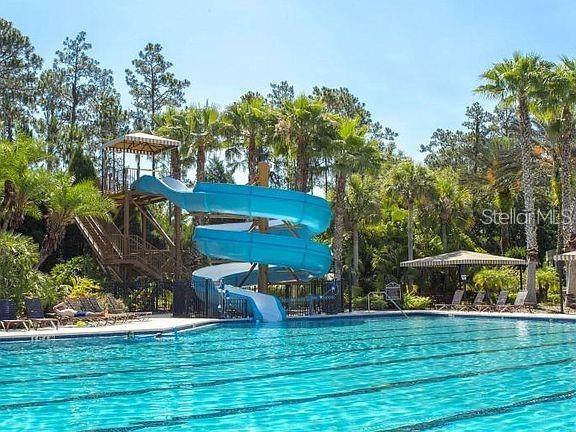 view of swimming pool with a water slide