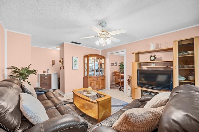 tiled living room featuring ceiling fan and a textured ceiling